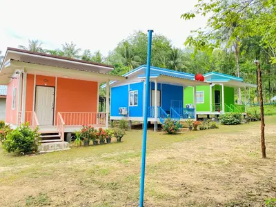 a house with a blue pole in front of it at TR Bungalow in Ban Tha Rua