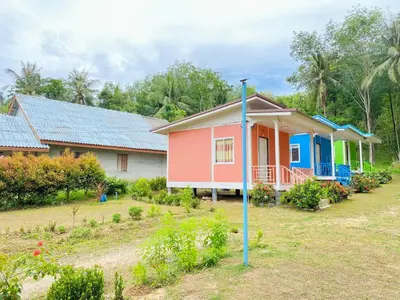 a house with a blue pole in front of it at TR Bungalow in Ban Tha Rua