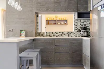 a kitchen with a counter and a refrigerator at CityGate by Villacarte in Kamala Beach