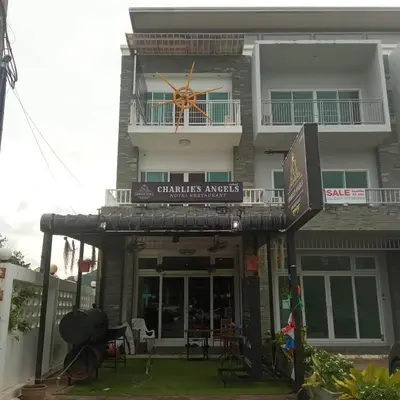 a building with a clock on top of it at Charlie's Angels Hotel Restaurant in Rawai Beach