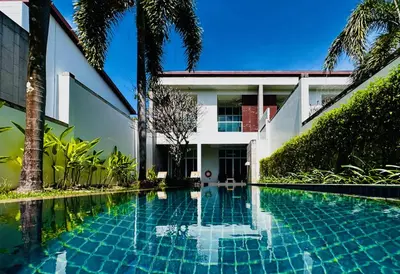 a swimming pool in front of a house at White Lotus by Oxygen at Bang Tao Beach in Ban Thalat Choeng Thale