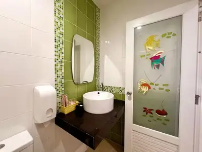 a bathroom with a sink and a mirror at The Snug Airportel - Phuket Airport in Nai Yang Beach