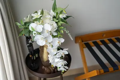 a vase filled with white flowers on a table at Sunpao Pool Villa by HCR in Layan Beach