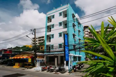 a blue and white building on the side of a street at PATONG BLUE HOTEL in Patong Beach