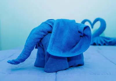 a blue stuffed animal sitting on a bed at PATONG BLUE HOTEL in Patong Beach