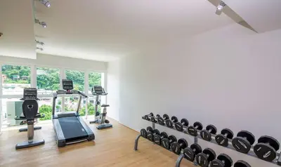 a gym with several tread machines in a room at KATA BEACH OZONE Superb Fully Equipped studio kitchen washing machine aircon in Kata Beach