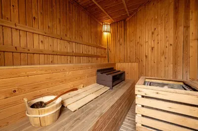 an inside of a wooden sauna with a bucket at Phuket Leelavadee Hua Ting Resort in Patong Beach
