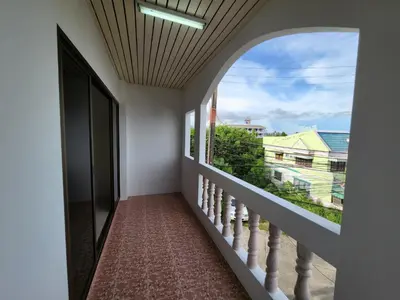 a hallway with a large window and a staircase at Hommory Residence - West Chalong in Ban Klang