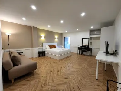 a large living room with a couch and a television at Hommory Residence - West Chalong in Ban Klang