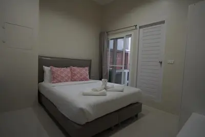 a bedroom with a bed with two stuffed animals on it at Hommory Residence - West Chalong in Ban Klang