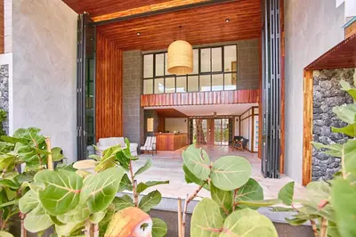 an open lobby with a stone wall at Title V by Villacarte in Rawai Beach
