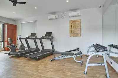 a gym with several tread machines in a room at Title V by Villacarte in Rawai Beach