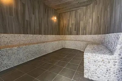 a stone bench in a room with a tile floor at Title V by Villacarte in Rawai Beach