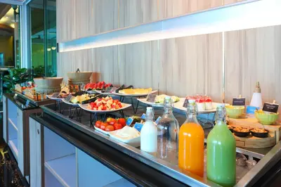 a buffet line with many plates of food and drinks at Sira Grande Hotel, Patong in Patong Beach