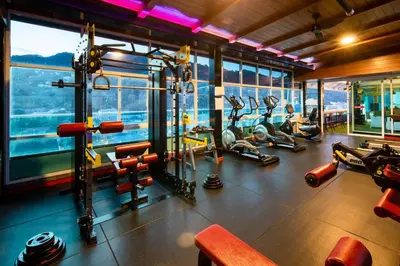 a gym with several people working out in a building at Sira Grande Hotel, Patong in Patong Beach
