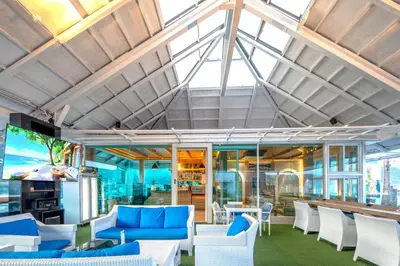 a room with blue and white chairs and tables at Sira Grande Hotel, Patong in Patong Beach