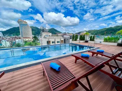 a swimming pool on the roof of a building at Centro One Patong in Patong Beach