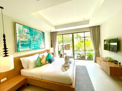 a bedroom with a bed and a large window at Superbe villa tropicale avec piscine privée Phuket in Phuket Town