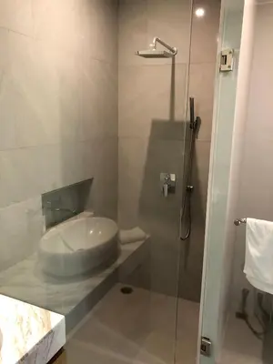 a bathroom with a sink and a glass shower at Superbe villa tropicale avec piscine privée Phuket in Phuket Town