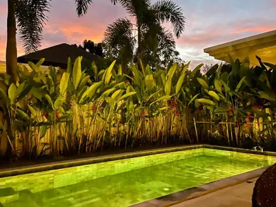 a swimming pool in a garden with plants at Superbe villa tropicale avec piscine privée Phuket in Phuket Town