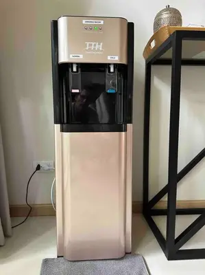 a drink machine is sitting next to a table at Superbe villa tropicale avec piscine privée Phuket in Phuket Town