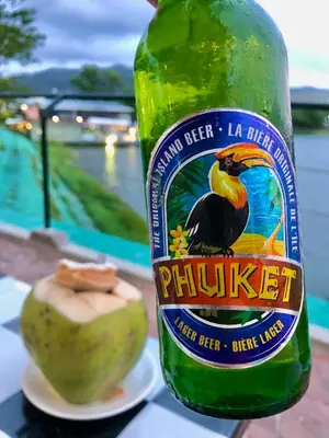 a bottle of phuket beer next to an apple at Superbe villa tropicale avec piscine privée Phuket in Phuket Town