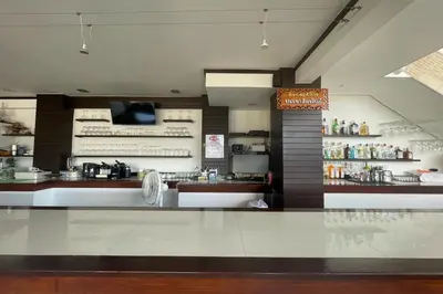 a restaurant with a counter in the middle of a room at Swiss Villas Panoramic - Hillside Beach View in Patong Beach
