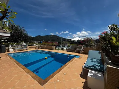 a swimming pool on top of a building at Swiss Villas Panoramic - Hillside Beach View in Patong Beach