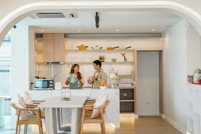 a man and woman standing in a kitchen at The Tint At Phuket Town - SHA Plus in Phuket Town