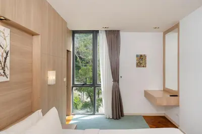 a bedroom with a large window and a bed at Deluxe apartment at Icon Park by Lofty in Kamala Beach