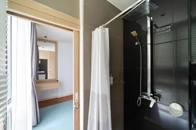 a bathroom with a shower with a shower curtain at Deluxe apartment at Icon Park by Lofty in Kamala Beach
