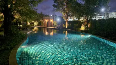 a swimming pool in a park at night at Cozy Apartment Close to Amazing Beach ! 39 Sqm in Phuket Town