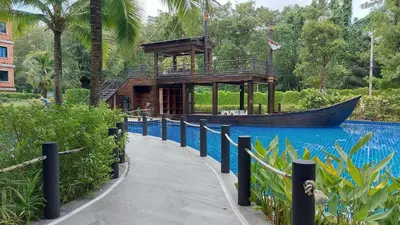 a wooden building next to a boat in the water at Cozy Apartment Close to Amazing Beach ! 39 Sqm in Phuket Town
