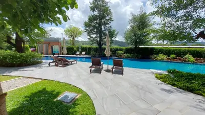 a patio with two chairs and a pool at Cozy Apartment Close to Amazing Beach ! 39 Sqm in Phuket Town