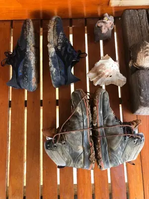 a group of shoes sitting on a wooden table at Artist Homestay in Ko Yao Noi