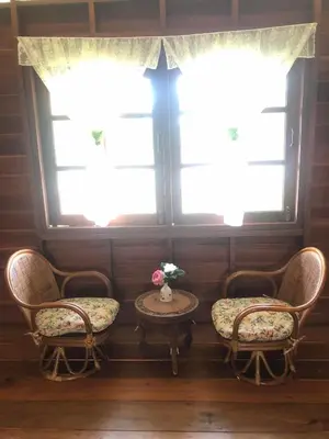two chairs and a table in front of a window at Artist Homestay in Ko Yao Noi