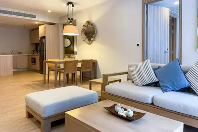 a living room with a couch and a table at Baan Mai Khao - 2 Bedroom Luxury Condo - Direct Pool & Beach Access in Mai Khao Beach