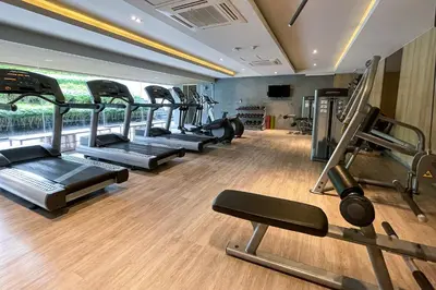 a gym with several treadmills and a row of exercise bikes at Baan Mai Khao - 2 Bedroom Luxury Condo - Direct Pool & Beach Access in Mai Khao Beach