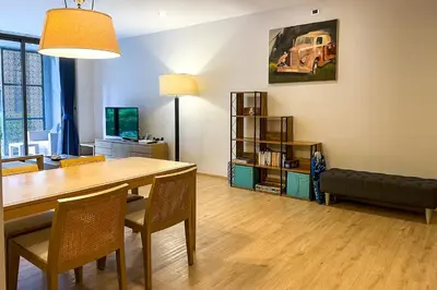 a living room with a dining room table and a couch at Baan Mai Khao - 2 Bedroom Luxury Condo - Direct Pool & Beach Access in Mai Khao Beach