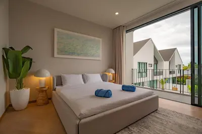 a bedroom with a large bed and a large window at Modern 4BR Villa with Private Pool in Bangtao in Bang Tao Beach