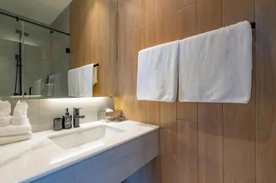 a bathroom with a white sink and a mirror at Modern 4BR Villa with Private Pool in Bangtao in Bang Tao Beach