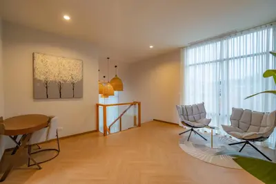 a living room with two chairs and a table at Modern 4BR Villa with Private Pool in Bangtao in Bang Tao Beach