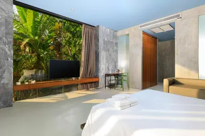 a hotel room with a bed and a large window at Romantic villa in the tropics near Kamala Beach in Kamala Beach