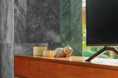 a small toy pig sitting on a desk next to a computer monitor at Romantic villa in the tropics near Kamala Beach in Kamala Beach