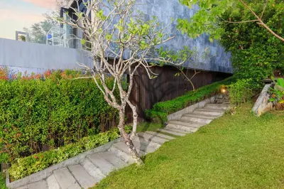 a stairway leading up to a building with a tree at Romantic villa in the tropics near Kamala Beach in Kamala Beach