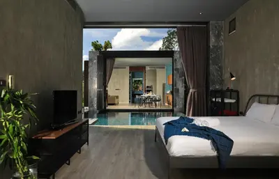 a bedroom with a bed and a tv and a pool at Seclusion in the mountains, villa near Kamala beach in Kamala Beach
