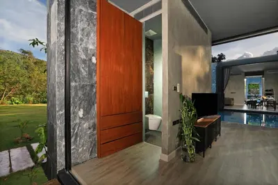 a pivot door in a house with a pool at Seclusion in the mountains, villa near Kamala beach in Kamala Beach