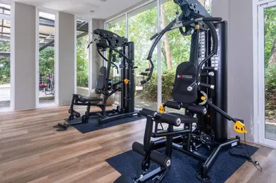 a gym with three tread machines in a room at The tree seaview and quiet surrounded by trees 75smetre in Kamala Beach