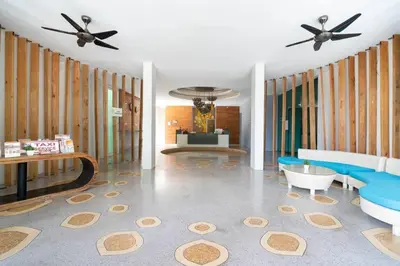 a living room with blue furniture and a ceiling fan at The tree seaview and quiet surrounded by trees 75smetre in Kamala Beach