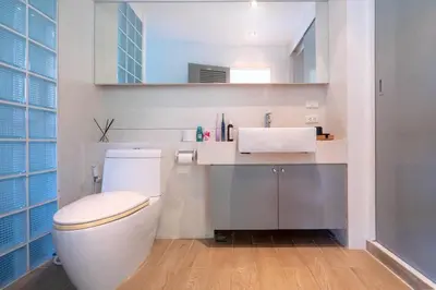 a bathroom with a white toilet and a sink at The tree seaview and quiet surrounded by trees 75smetre in Kamala Beach